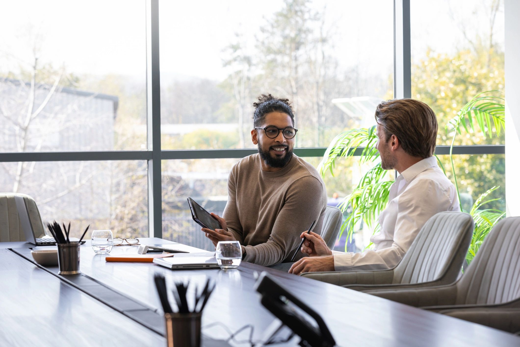 Professionals reviewing a financial transaction at a conference table