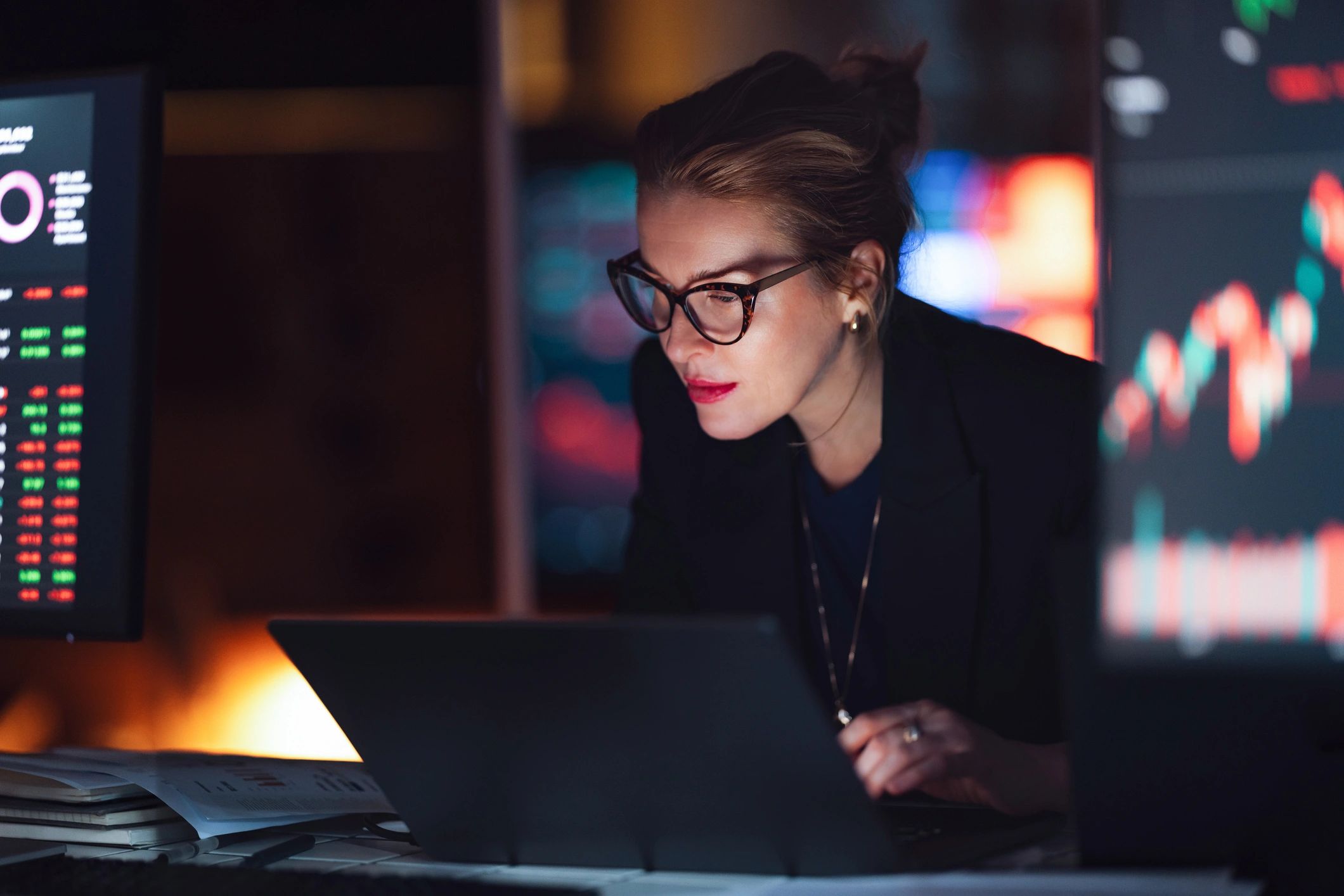 Financial analyst reviewing market charts on a laptop